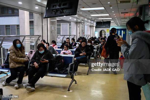 Children and their parents wait at an outpatient area at a children hospital in Beijing on November 23, 2023. The World Health Organization has asked...