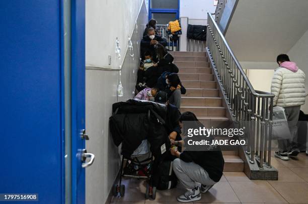 Children receive a drip on the stairs at a children hospital in Beijing on November 23, 2023. The World Health Organization has asked on November 23...