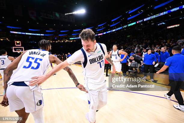 Derrick Jones Jr. #55 of the Dallas Mavericks embraces Luka Doncic of the Dallas Mavericks after the game against the Los Angeles Lakers on November...