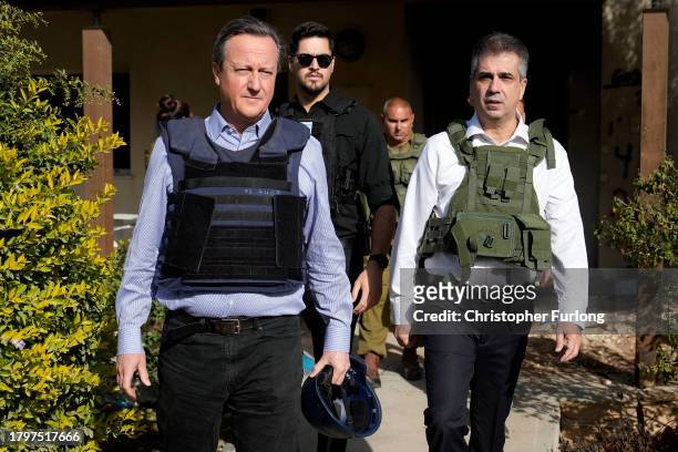 David Cameron , the new UK foreign secretary and former prime minister, views a home destroyed in last month's Hamas attack with Israeli Foreign...