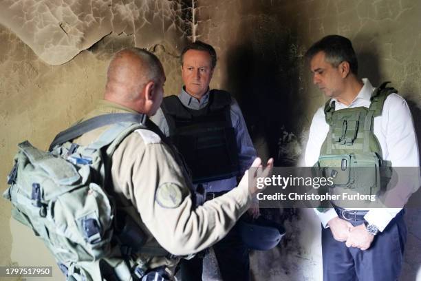 David Cameron, the new UK foreign secretary and former prime minister, views a home destroyed in last month's Hamas attack with Israeli Foreign...