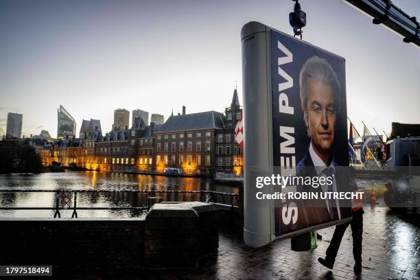 An election sign of Party for Freedom leader Geert Wilders is removed near the Binnenhof, a day after the Netherlands general elections, in the Hague...
