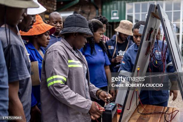 Qualifying electricians test how a solar panel works during the practical part of the training at Nkangala's Top of the World Training Centre in...
