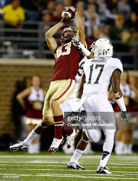 Alex Amidon of the Boston College Eagles catches a pass in front of A.J. Marshall of the Wake Forest Demon Deacons in the first quarter during the...
