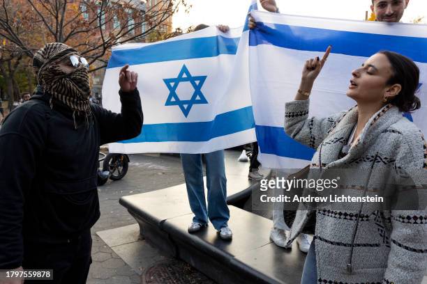 Supporters of Israel exchange insults with supporters of Palestine as they counter protest a larger demonstration of New York University students...