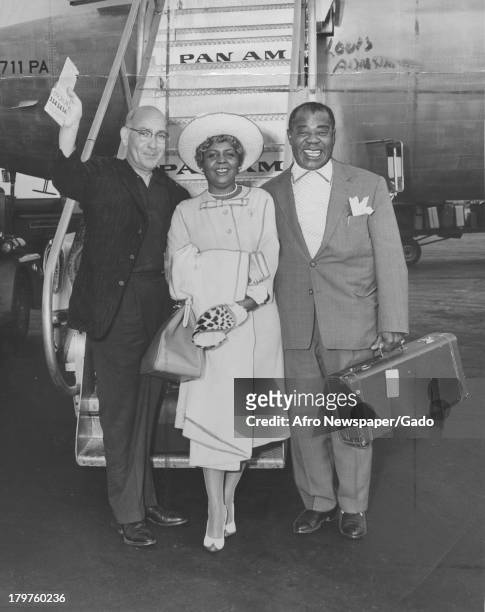 Trumpet King Louis Armstrong and his wife, Lucile, at International Airport before they boarded Pan American World Airways jet clipper for Rome, New...