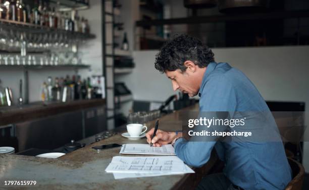 remote work, man writing on paper and coffee shop, restaurant or pub. freelancer, documents and business person in cafe diner with financial form, accounting report and budget planning or bookkeeping - bookkeeping stock pictures, royalty-free photos & images