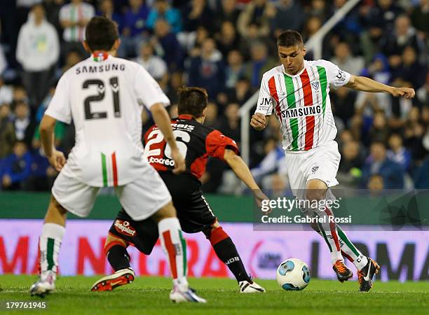 Fernanado Tobio of Velez Sarsfield fights for the ball with Cristian Diaz of Newell's Old Boys during a match between Velez Sarsfield and Newell's...