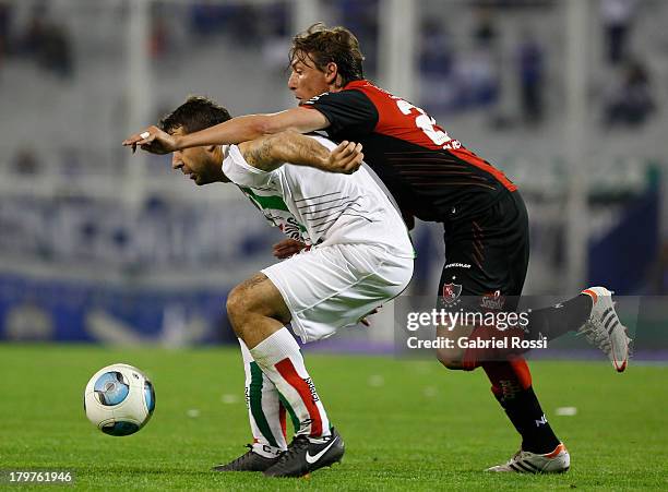 Lucas Pratto of Velez Sarsfield fights for the ball with Gabriel Heinze of Newell's Old Boys during a match between Velez Sarsfield and Newell's Old...