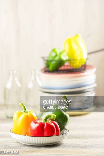 red, yellow, and green peppers placed on the table. - gele paprika stockfoto's en -beelden