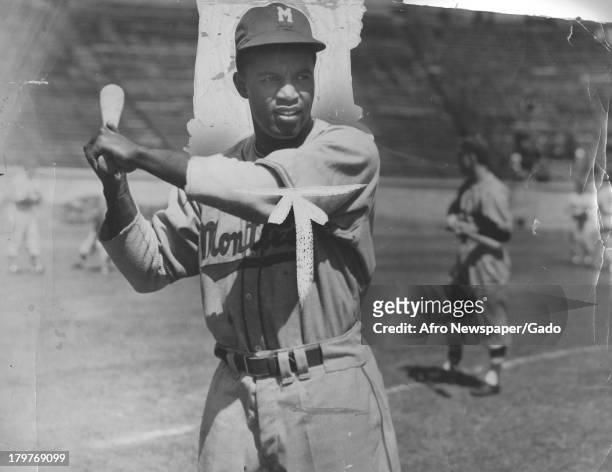American baseball player Jackie Robinson , later of the Brooklyn Dodgers, stands at the plate waiting for a pitch during a Montreal Royals practice,...