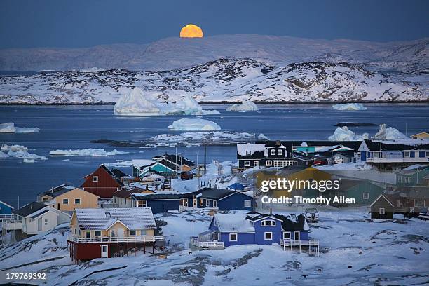 full moon,icebergs & colourful houses in ilulissat - ilulissat stock pictures, royalty-free photos & images