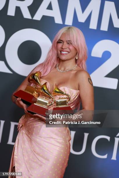 Karol G poses with the awards for Best Recording of the Year, Best Urban Album of the Year, and Best Album of the Year in the media center for The...
