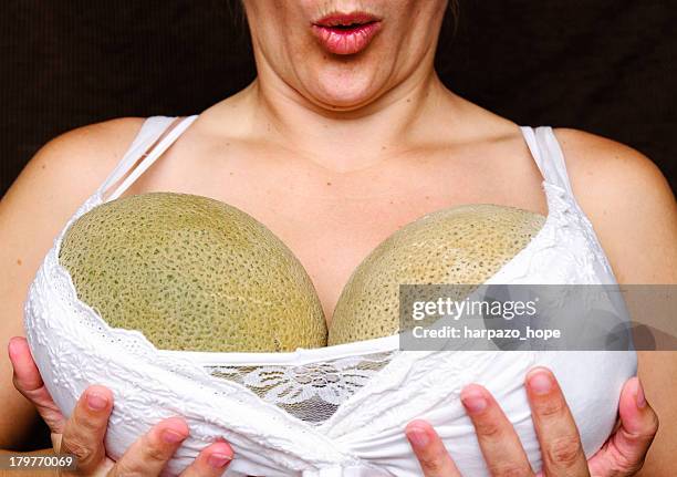 woman holding melons - borstkas stockfoto's en -beelden