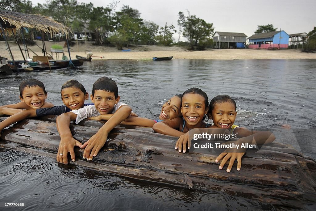 Amazonian children play in Rio Negro river