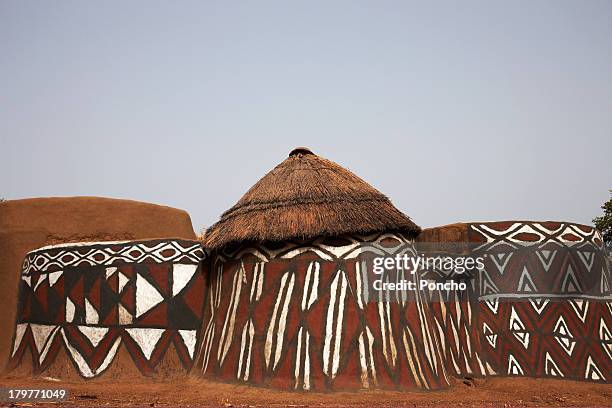 traditionally painted mud huts - rieten dak stockfoto's en -beelden