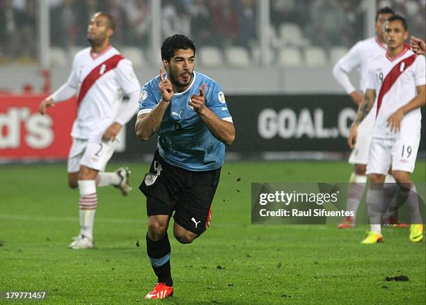 Luis Suarez of Uruguay celebrates the first goal during a match between Peru and Uruguay as part of the 15th round of the South American Qualifiers...