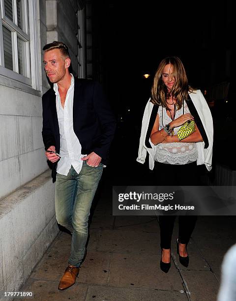 Trinny Woodall leaves Lulu Private Member's Club with a mystery younger man. On September 6, 2013 in London, England.