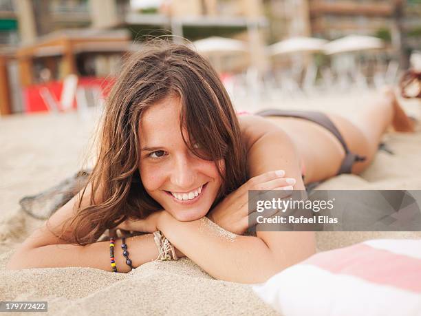 smiling bikini woman lying on the beach - salou imagens e fotografias de stock