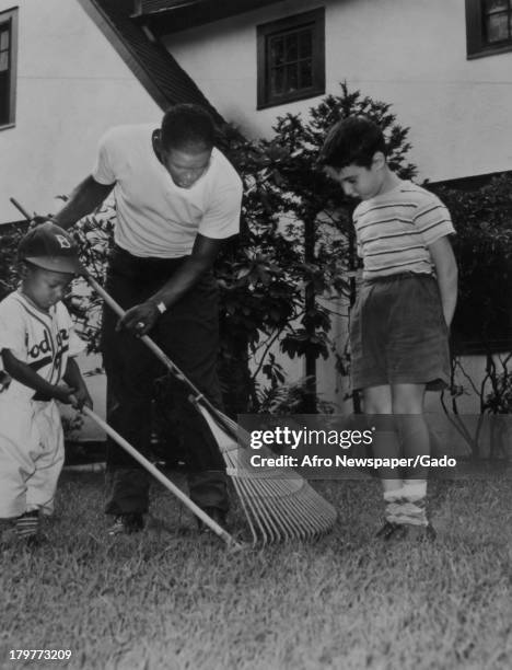 Day at home before a night game doesn't mean much rest for American baseball player Jackie Robinson of the Brooklyn Dodgers, but he gets plenty of...