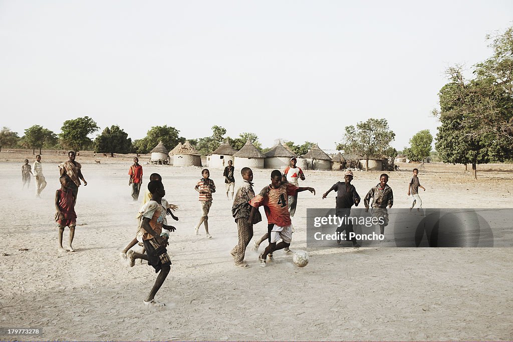 Boys playing football in their village