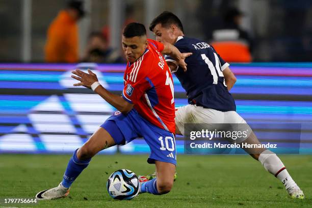 Alexis Sanchez of Chile competes for the ball with Andrés Cubas of Paraguay during a FIFA World Cup 2026 Qualifier match between Chile and Paraguay...