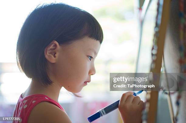 girl drawing picture - concentration ストックフォトと画像