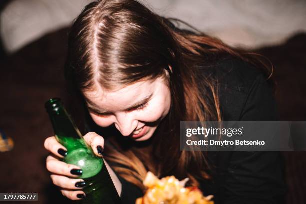 happy young woman having beer at party - betrunken stock-fotos und bilder