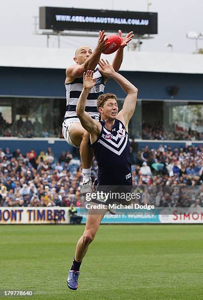 James Podsiadly of the Cats marks the ball high over Zac Dawson of the Dockers during the Second AFL Qualifying Final match between the Geelong Cats...