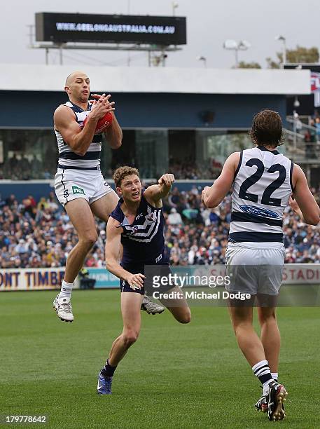 James Podsiadly of the Cats marks the ball high over Zac Dawson of the Dockers during the Second AFL Qualifying Final match between the Geelong Cats...