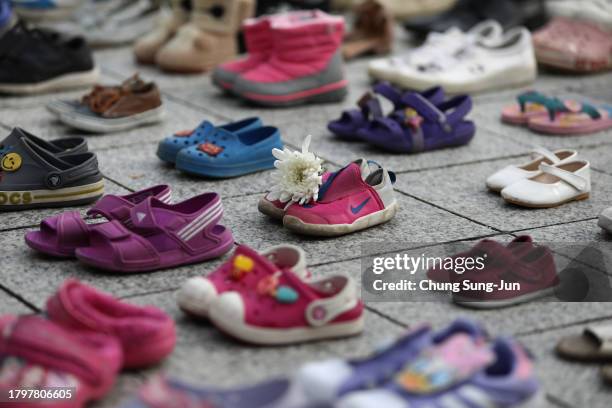 Floral tribute is placed on a pair of baby shoes symbolizing Palestinian victims during a rally for Gaza on November 17, 2023 in Seoul, South Korea....