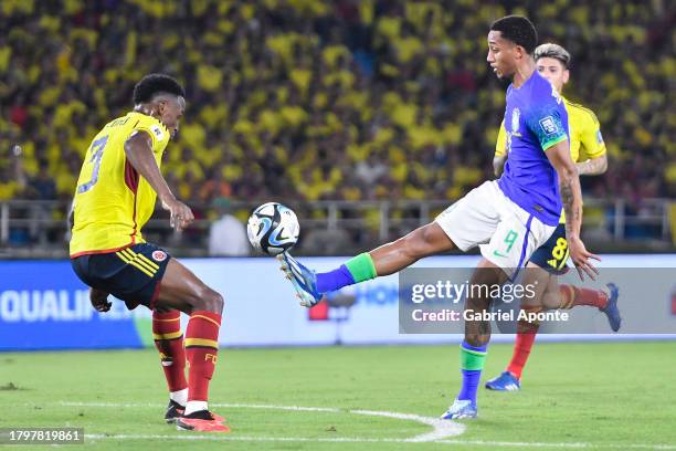 João Pedro of Brazil battles for possession with Davinson Sanchez of Colombia during the FIFA World Cup 2026 Qualifier match between Colombia and...