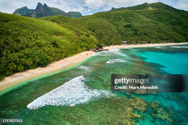 high view of coral reef and mountains on waya island in the yasawa islands - yasawa island group stock pictures, royalty-free photos & images