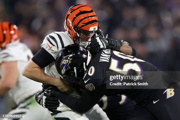 Jake Browning of the Cincinnati Bengals is tackled by Kyle Van Noy of the Baltimore Ravens during the fourth quarter of the game at M&T Bank Stadium...