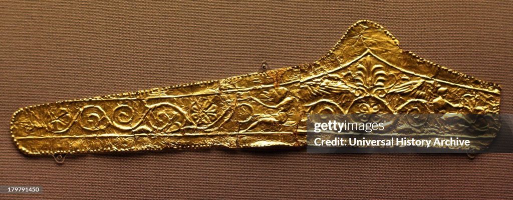 Gold pediment-shaped diadems 330-300 BC. These diadems are made of thin sheet gold with die-formed designs. The most elaborate of them has a central palmette and winged figures on either side with scroll work beyond. The Kyme Treasure contained fragm