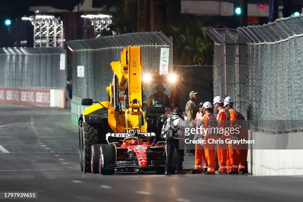 The car of Carlos Sainz of Spain and Ferrari is removed from the circuit after stopping on track during practice ahead of the F1 Grand Prix of Las...