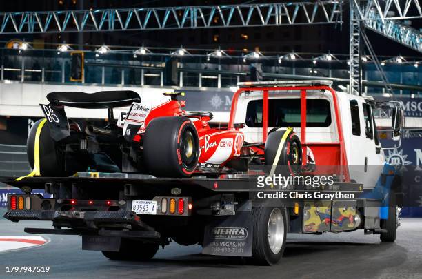 The car of Carlos Sainz of Spain and Ferrari is removed from the circuit on a truck after stopping on track during practice ahead of the F1 Grand...