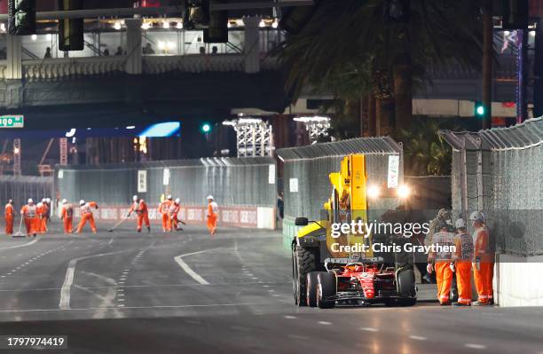 The car of Carlos Sainz of Spain and Ferrari is removed from the circuit on a truck after stopping on track during practice ahead of the F1 Grand...