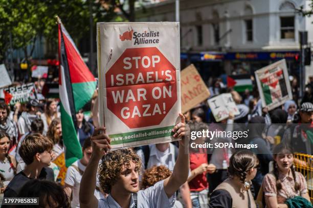 Demonstrators march down Swanston Street placards and banners during the protest. Hundreds of primary and secondary school students partake in a...