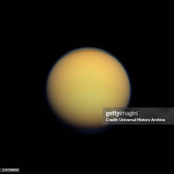 Titan's atmosphere makes Saturn's largest moon look like a fuzzy orange ball in this natural color view from the Cassini spacecraft. Titan.