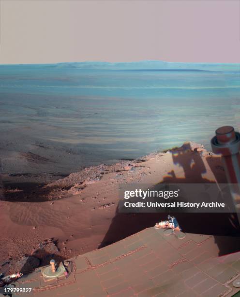 S Mars Rover Opportunity catches its own late-afternoon shadow in this dramatically lit view eastward across Endeavour Crater on Mars.