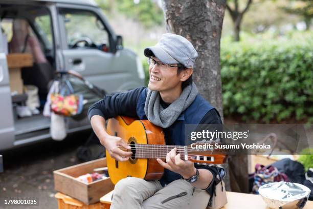 people gathered at an agricultural harvest festival held in a suburban park. - plucking an instrument foto e immagini stock