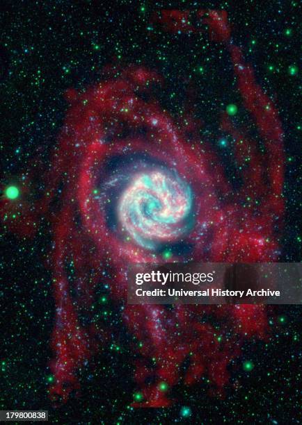 The outlying regions around the Southern Pinwheel galaxy, or M83, are highlighted in this composite image from NASA's Galaxy Evolution Explorer