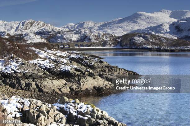 Winter view across Loch Nan Uamh, towards the rail viaduct on the West Highland line, West Highlands, Scotland, United Kingdom.