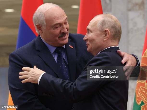 Russian President Vladimir Putin embraces Belarussian President Alexander Lukashenko during the SCTO Summit on November 23 in Minsk, Belarus....