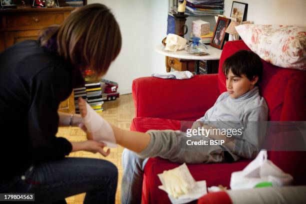 Nurse Dispensing Care, Everyday life of an independent nurse, Bagnolet, France. Foot care after a plantar wart removal.