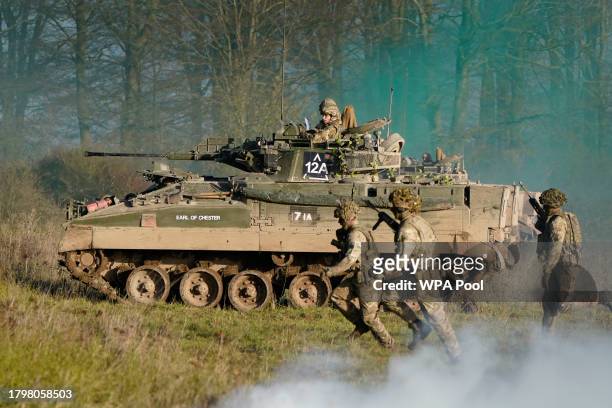 Prince William, The Prince of Wales, Colonel-in-Chief, 1st Battalion Mercian Regiment, rides in an armoured vehicle while on a training exercise...