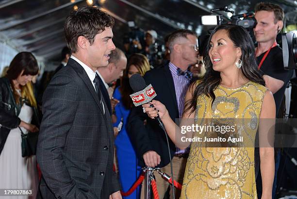 Zac Efron speaks with CTV eTalk host Tanya Kim at the premier of Parkland at Roy Thomson Hall on September 6, 2013 in Toronto, Canada.