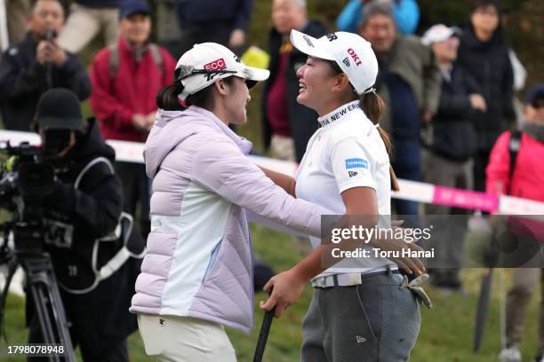 Yumeka Kobayashi of Japan is congratulated by P Saipan of Thailand after winning the tournament on the 18th green during the final round of Kyoto...