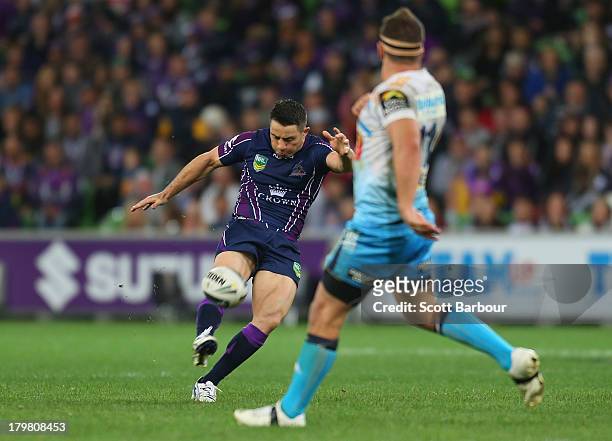 Cooper Cronk of the Storm kicks the winning field goal in extra time to win the round 26 NRL match between the Melbourne Storm and the Gold Coast...